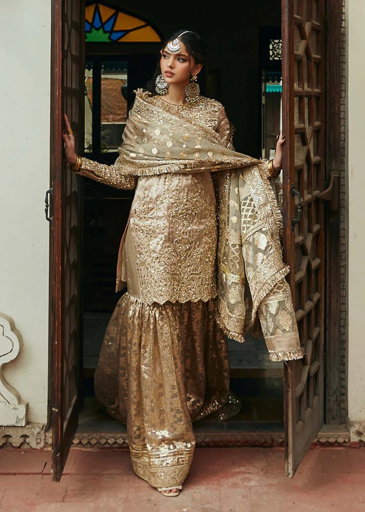Model wearing gold Chaman dress from Kanwal Malik, Afsheen Luxury Pret 2024 collection. Pakistani clothes online in UK, wedding clothes.