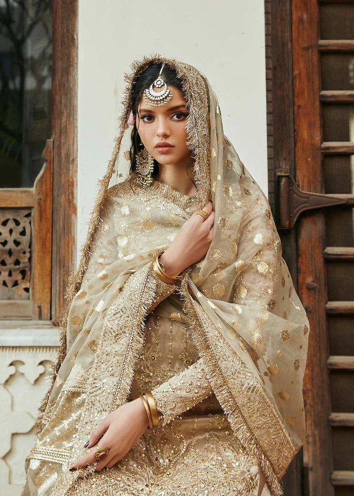 Model wearing gold Chaman dress from Kanwal Malik, Afsheen Luxury Pret 2024 collection. Pakistani clothes online in UK, wedding clothes.