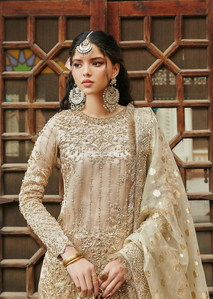 Model wearing gold Chaman dress from Kanwal Malik, Afsheen Luxury Pret 2024 collection. Pakistani clothes online in UK, wedding clothes.