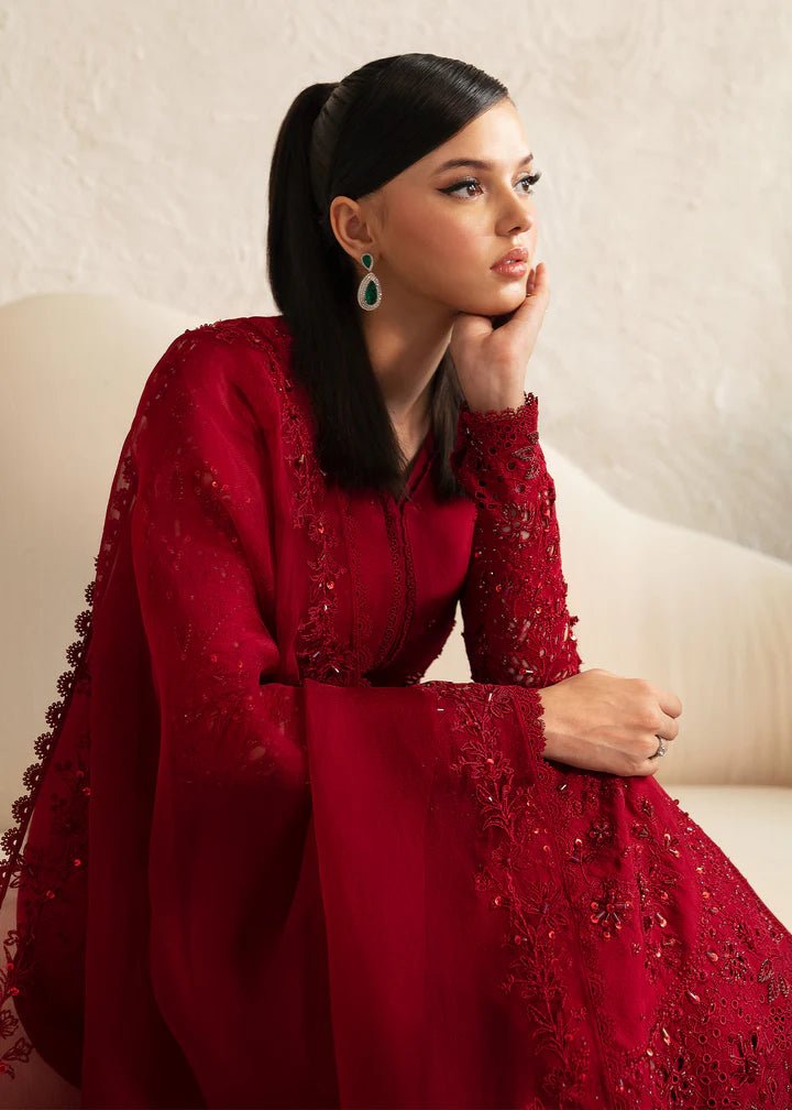 Model wearing a red Aleysa dress from Kanwal Malik. Elegant Pakistani wedding clothes available online in the UK. Perfect for luxury events and celebrations.