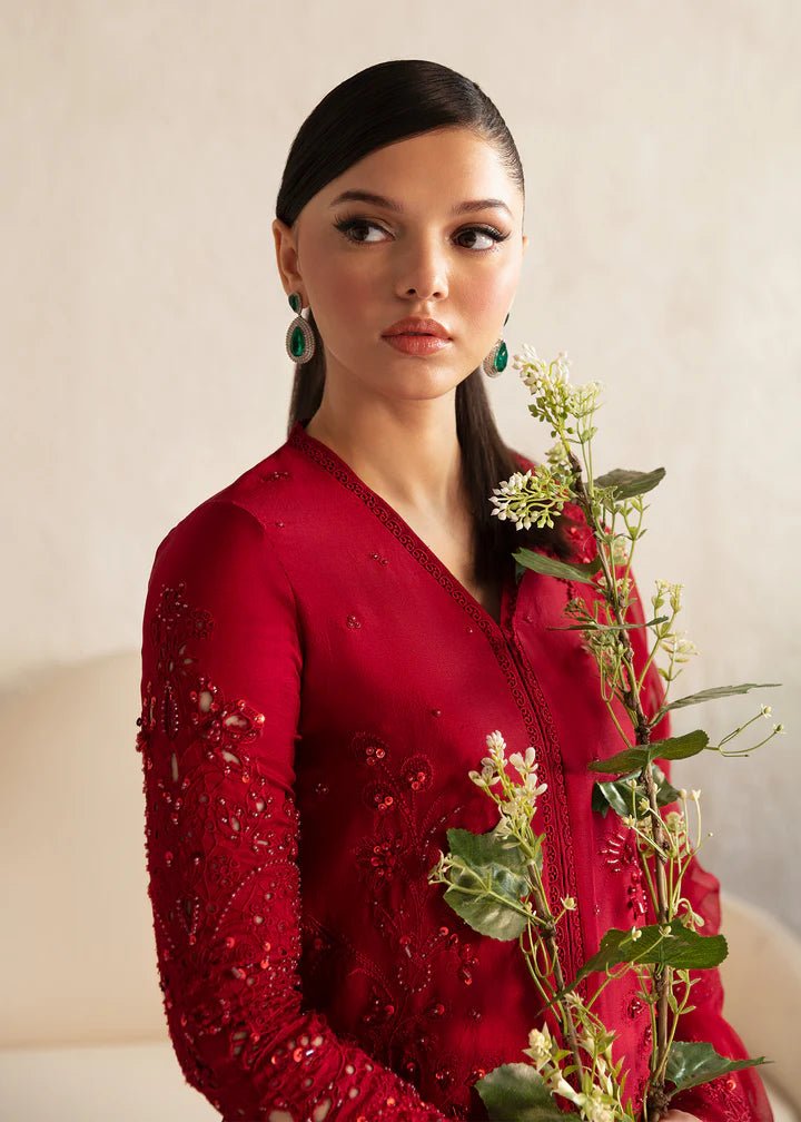 Model wearing a red Aleysa dress from Kanwal Malik. Elegant Pakistani wedding clothes available online in the UK. Perfect for luxury events and celebrations.