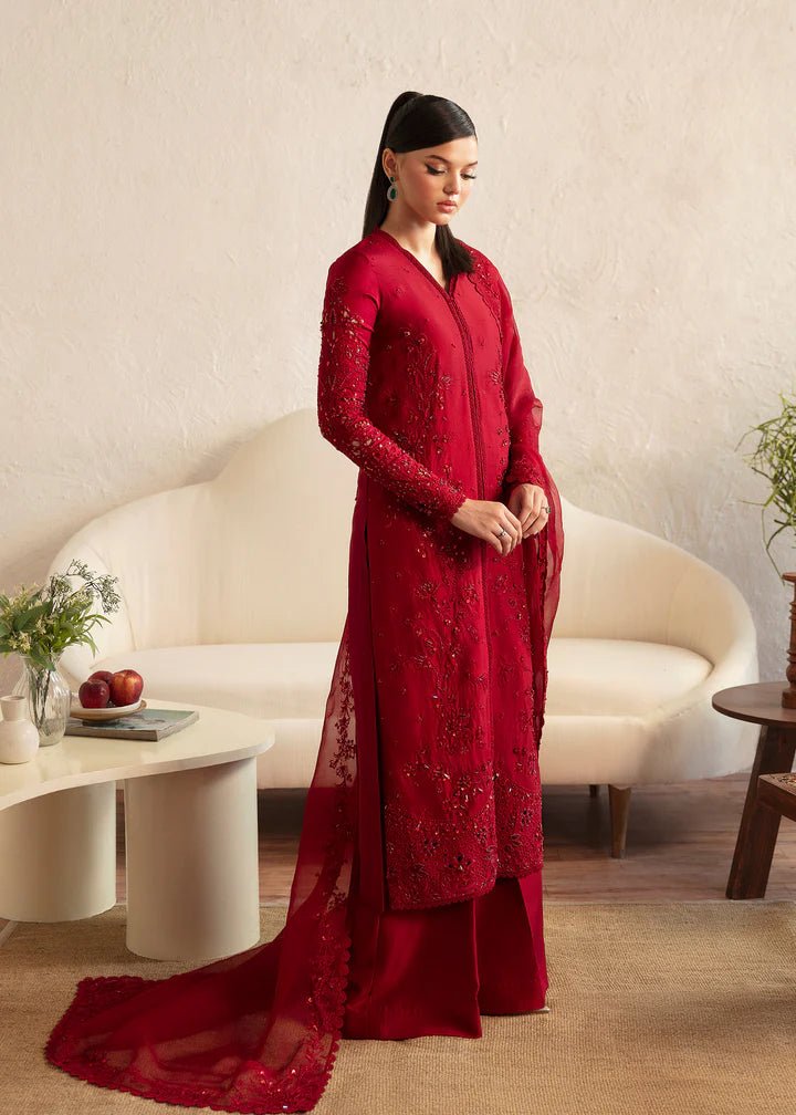 Model wearing a red Aleysa dress from Kanwal Malik. Elegant Pakistani wedding clothes available online in the UK. Perfect for luxury events and celebrations.