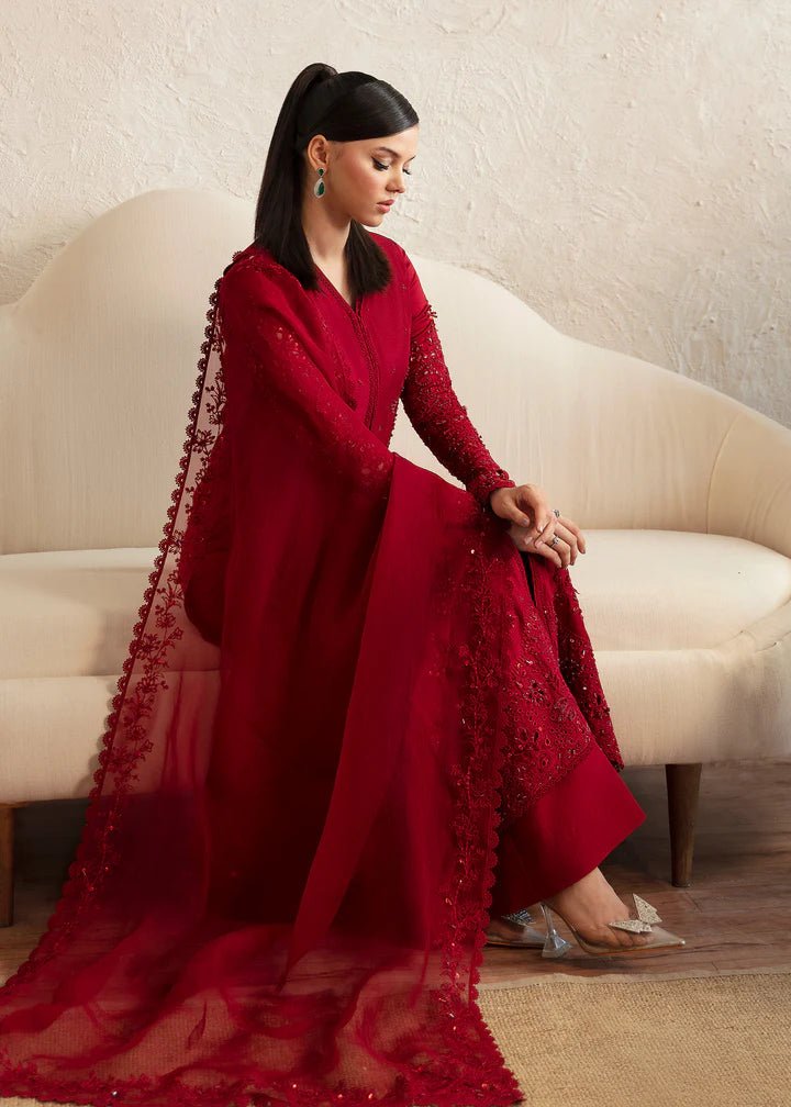 Model wearing a red Aleysa dress from Kanwal Malik. Elegant Pakistani wedding clothes available online in the UK. Perfect for luxury events and celebrations.