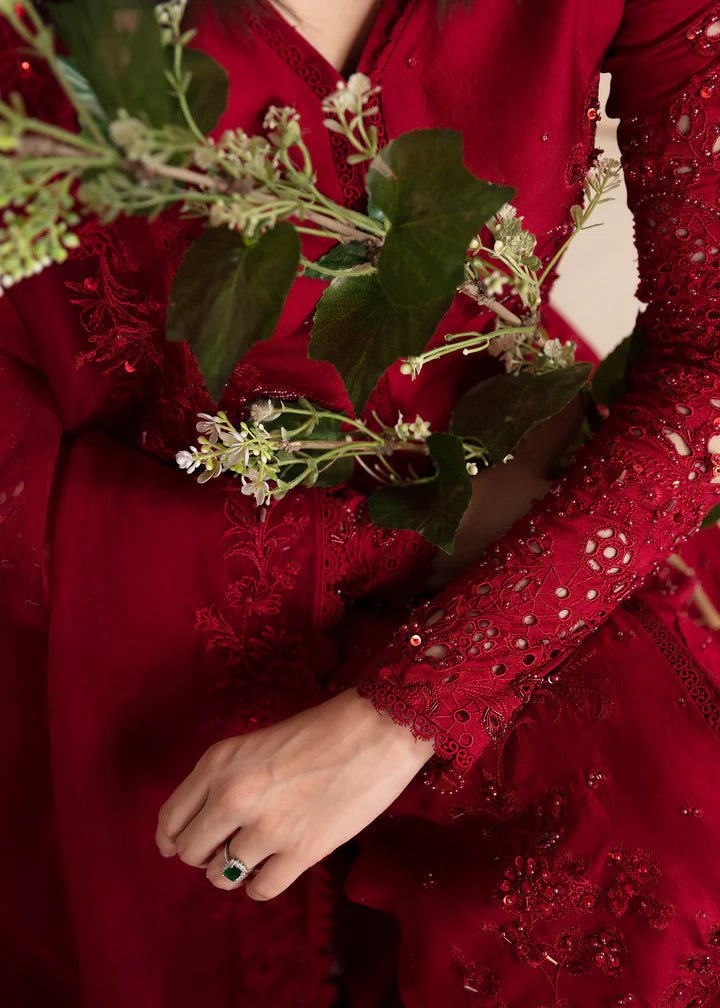 Model wearing a red Aleysa dress from Kanwal Malik. Elegant Pakistani wedding clothes available online in the UK. Perfect for luxury events and celebrations.