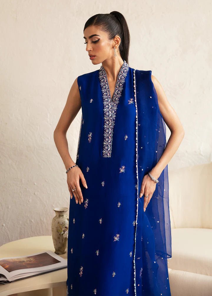 Model wearing blue Siya dress from Kanwal Malik. Featuring intricate embroidery and a matching dupatta, ideal for wedding and festive occasions. Perfect for those seeking Pakistani clothes online in the UK.