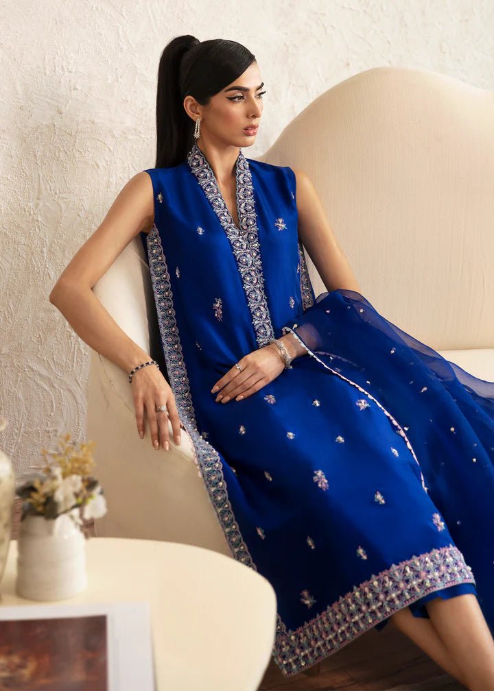 Model wearing blue Siya dress from Kanwal Malik. Featuring intricate embroidery and a matching dupatta, ideal for wedding and festive occasions. Perfect for those seeking Pakistani clothes online in the UK.