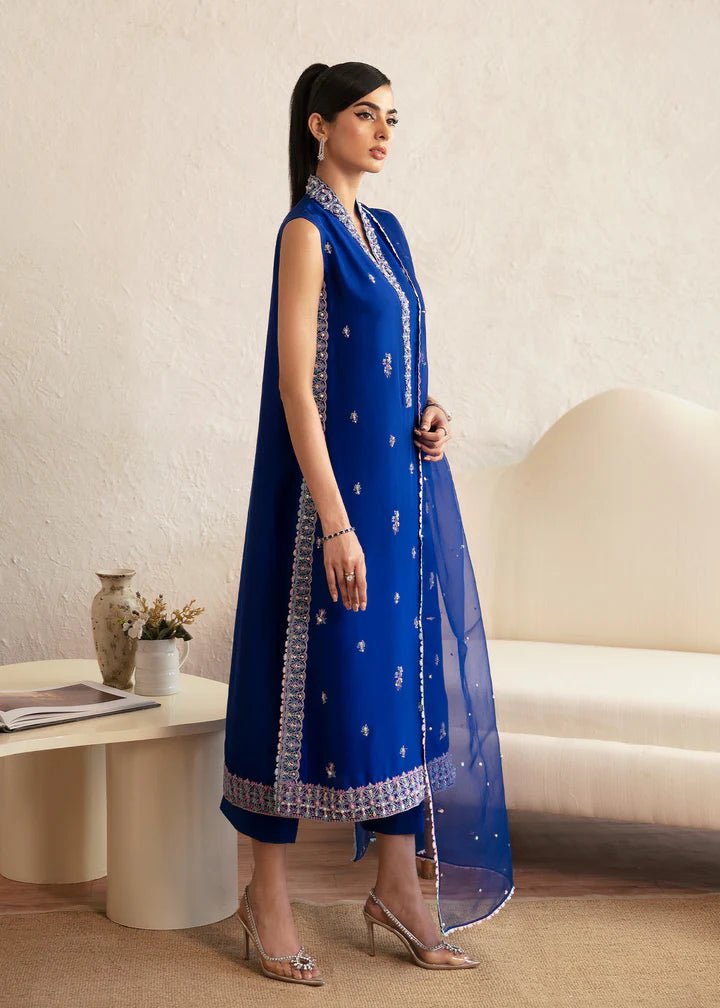 Model wearing blue Siya dress from Kanwal Malik. Featuring intricate embroidery and a matching dupatta, ideal for wedding and festive occasions. Perfect for those seeking Pakistani clothes online in the UK.