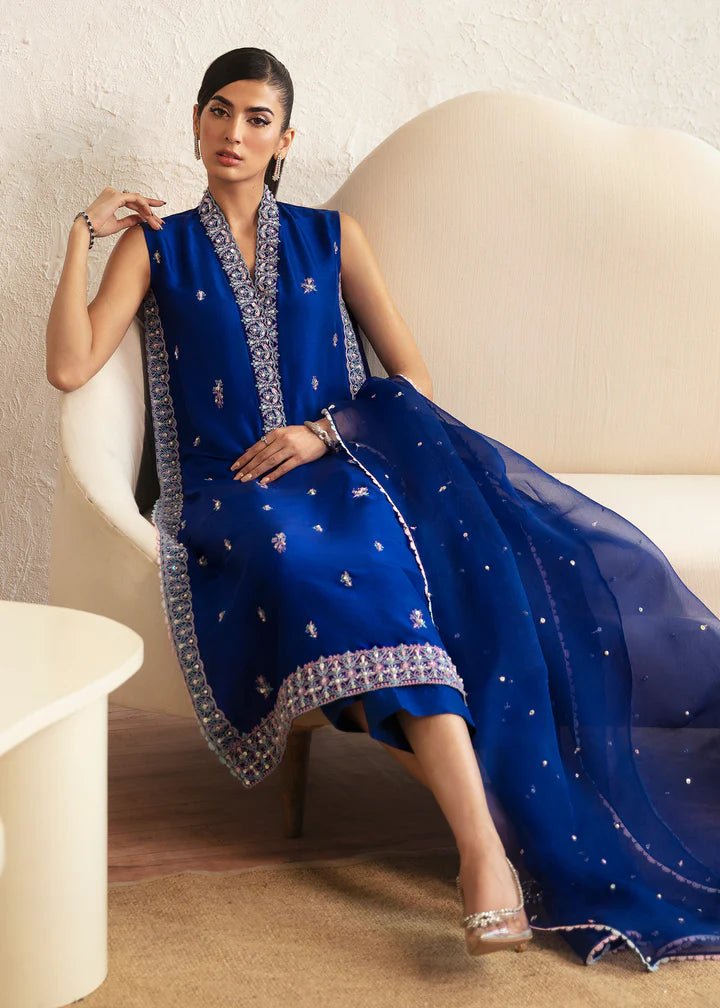 Model wearing blue Siya dress from Kanwal Malik. Featuring intricate embroidery and a matching dupatta, ideal for wedding and festive occasions. Perfect for those seeking Pakistani clothes online in the UK.