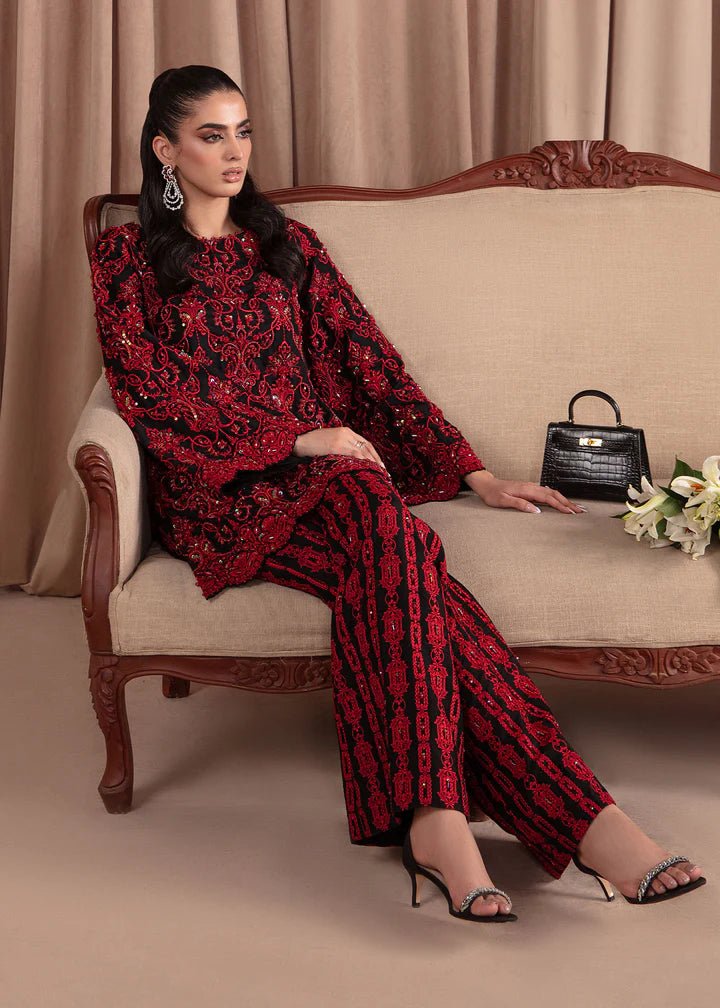 Model wearing Kanwal Malik Elara Luxury Pret '24 Allure dress in black and red, showcasing Pakistani wedding clothes online in the UK.