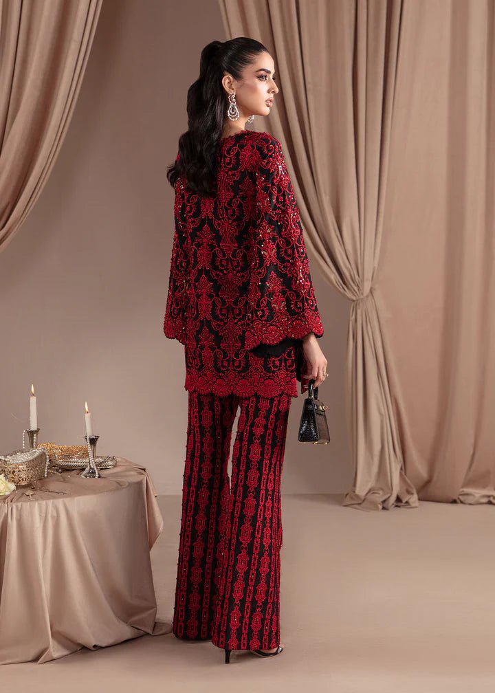 Model wearing Kanwal Malik Elara Luxury Pret '24 Allure dress in black and red, showcasing Pakistani wedding clothes online in the UK.