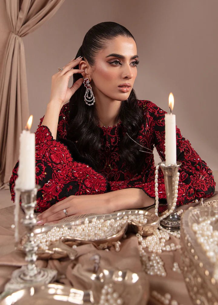 Model wearing Kanwal Malik Elara Luxury Pret '24 Allure dress in black and red, showcasing Pakistani wedding clothes online in the UK.