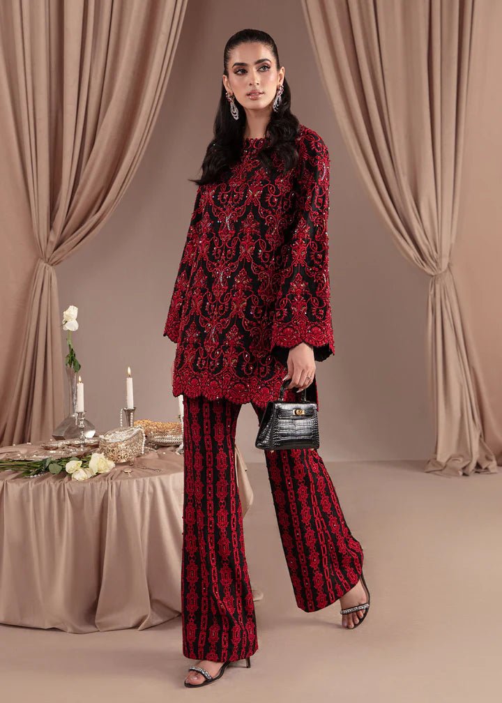 Model wearing Kanwal Malik Elara Luxury Pret '24 Allure dress in black and red, showcasing Pakistani wedding clothes online in the UK.