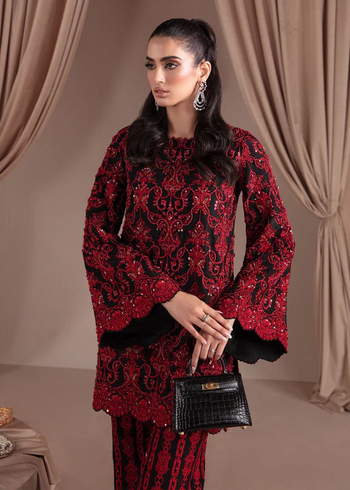 Model wearing Kanwal Malik Elara Luxury Pret '24 Allure dress in black and red, showcasing Pakistani wedding clothes online in the UK.