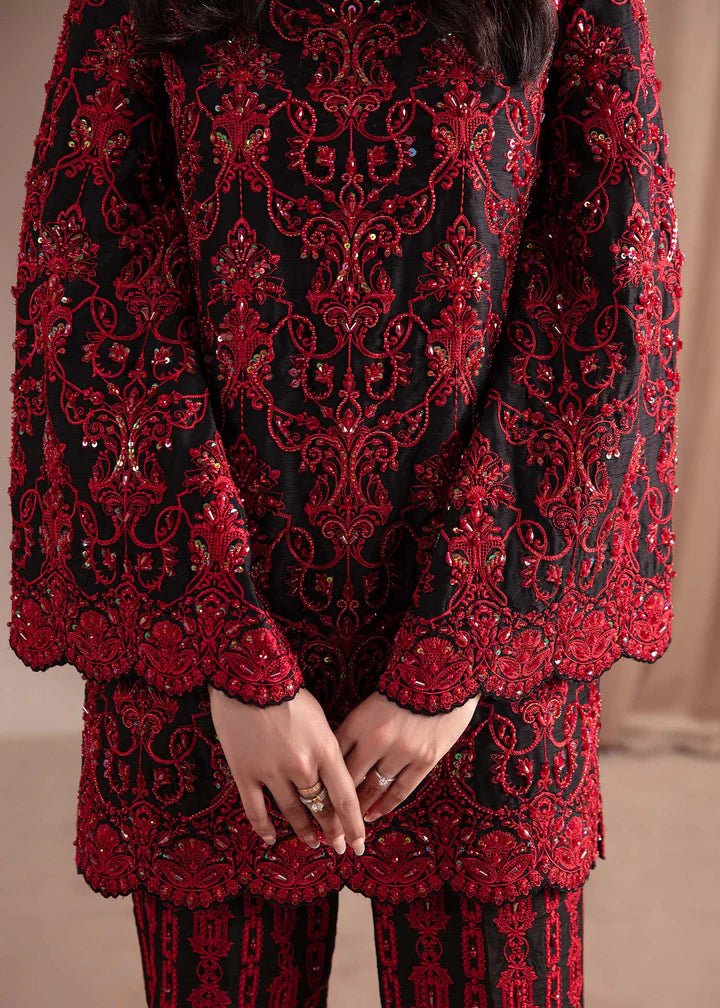 Model wearing Kanwal Malik Elara Luxury Pret '24 Allure dress in black and red, showcasing Pakistani wedding clothes online in the UK.Model wearing Kanwal Malik Elara Luxury Pret '24 Allure dress in black and red, showcasing Pakistani wedding clothes online in the UK.
