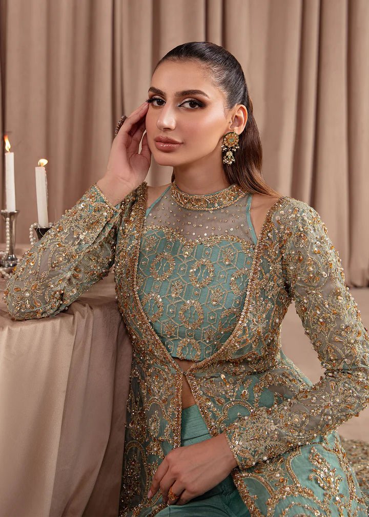 Model wearing Kanwal Malik Elara Luxury Pret '24 Aquamarine dress in teal, showcasing Pakistani wedding clothes online in the UK.
