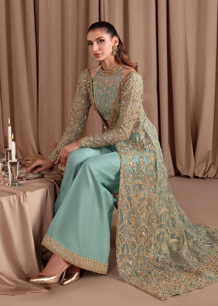 Model wearing Kanwal Malik Elara Luxury Pret '24 Aquamarine dress in teal, showcasing Pakistani wedding clothes online in the UK.