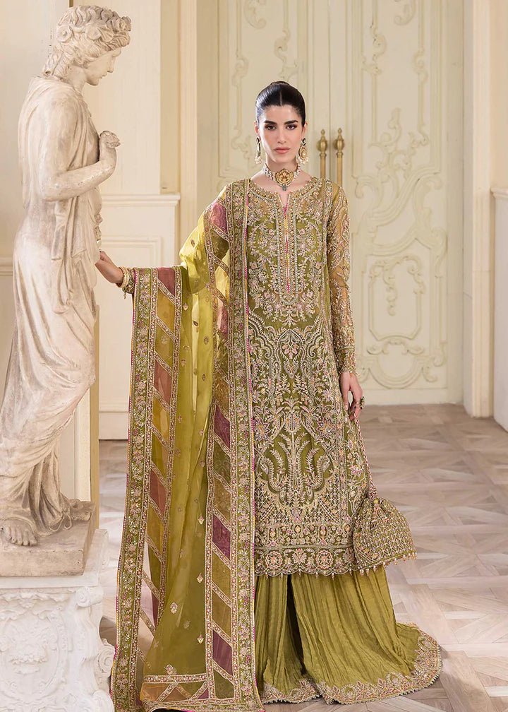 Model wearing Kanwal Malik Halena dress, olive green with pink accents, traditional Pakistani clothes UK.