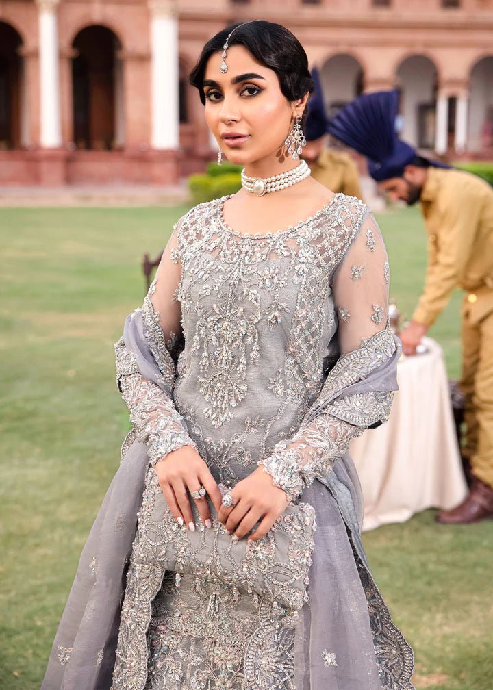 Model wearing Kanwal Malik Raaniyan Luxury Formals Kehkashan dress in silver, Pakistani bridal clothes online in UK.