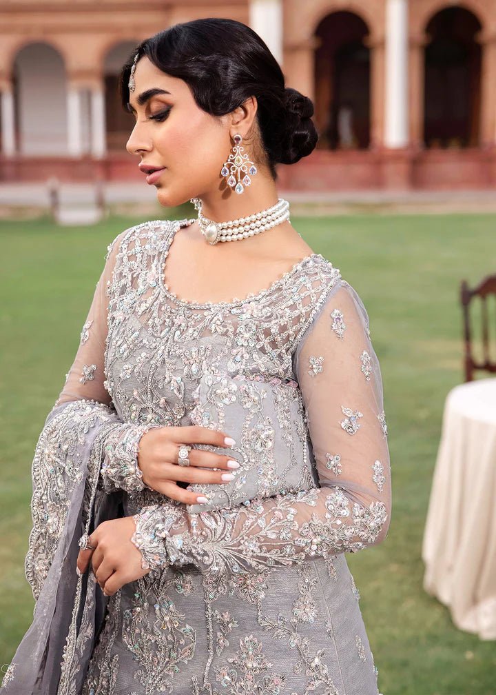 Model wearing Kanwal Malik Raaniyan Luxury Formals Kehkashan dress in silver, Pakistani bridal clothes online in UK.