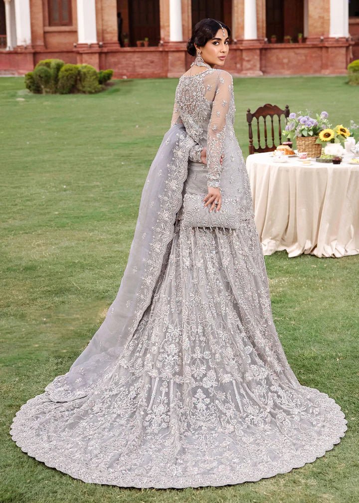 Model wearing Kanwal Malik Raaniyan Luxury Formals Kehkashan dress in silver, Pakistani bridal clothes online in UK.