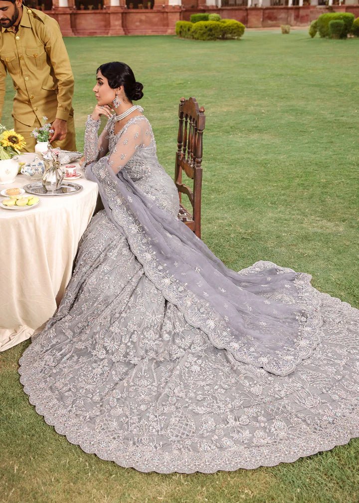 Model wearing Kanwal Malik Raaniyan Luxury Formals Kehkashan dress in silver, Pakistani bridal clothes online in UK.