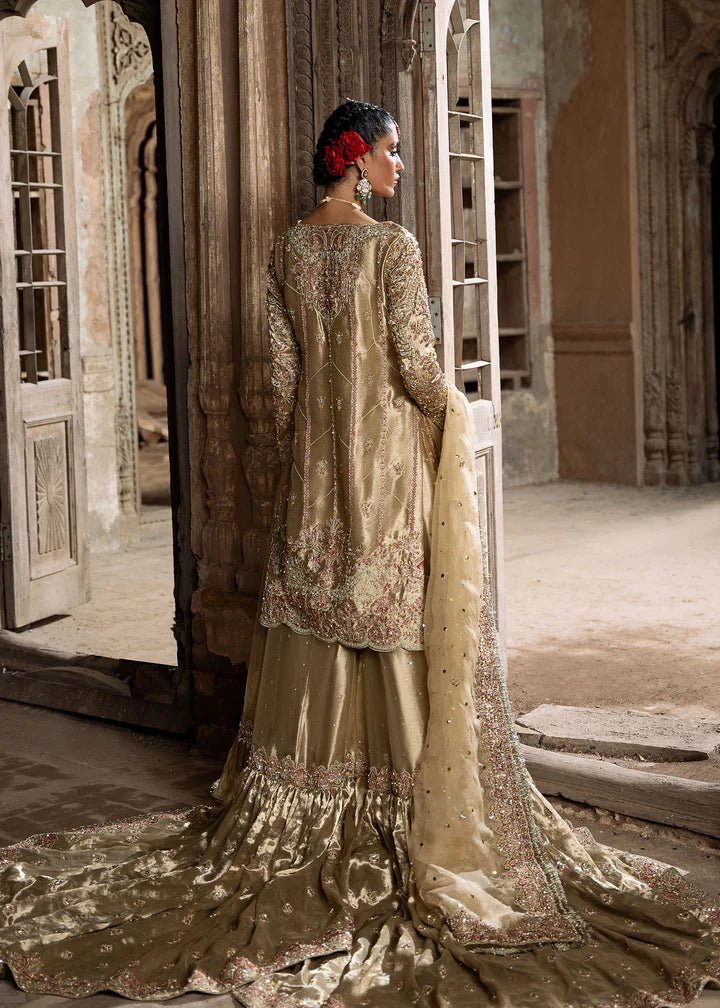 Explore Kanwal Malik's Shahnoor from the Sajni II Formal Collection, a luxurious gold ensemble featuring intricate pearl and sequin embellishments. Priced at £824. Shop Pakistani wedding clothes online in the UK at Signature Labels today!
