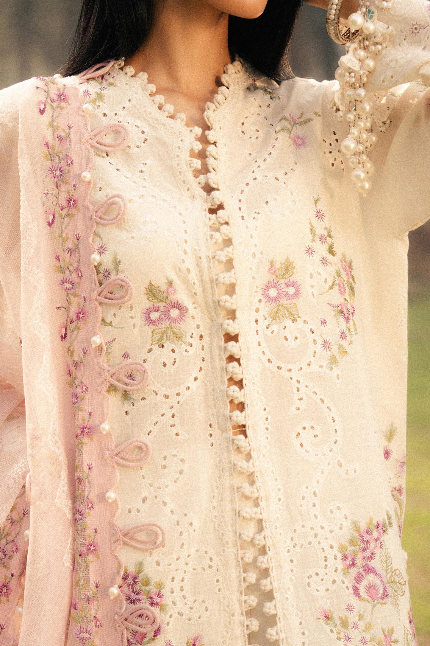 Model wearing ivory and pink embroidered outfit from Sana Safinaz, Luxury Lawn '25, perfect for Pakistani clothes online in UK.