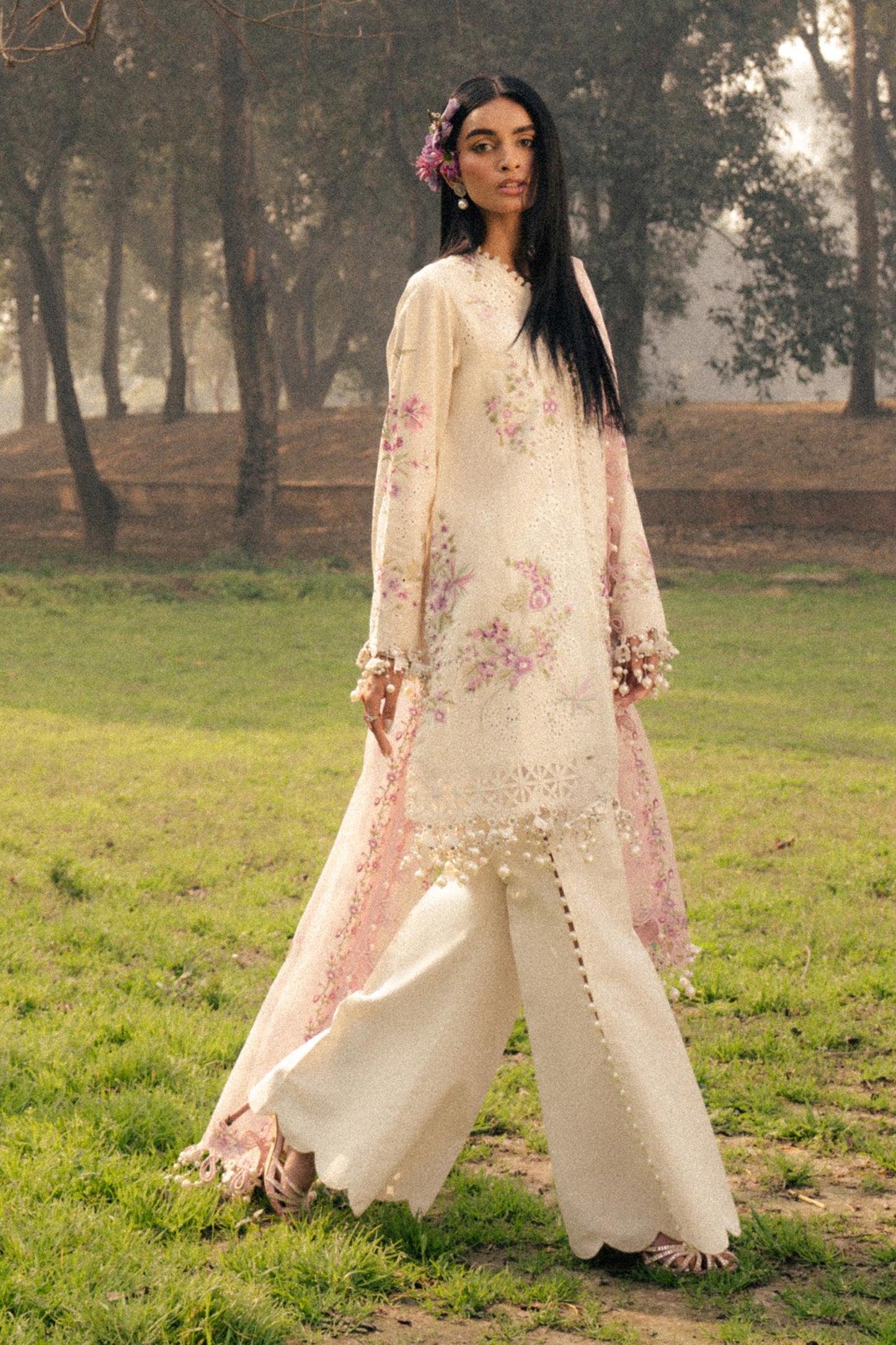 Model wearing ivory and pink embroidered outfit from Sana Safinaz, Luxury Lawn '25, perfect for Pakistani clothes online in UK.
