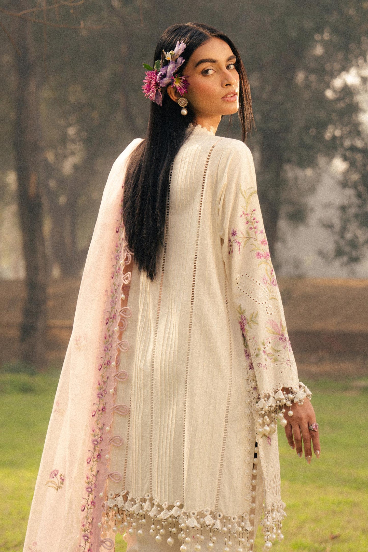 Model wearing ivory and pink embroidered outfit from Sana Safinaz, Luxury Lawn '25, perfect for Pakistani clothes online in UK.