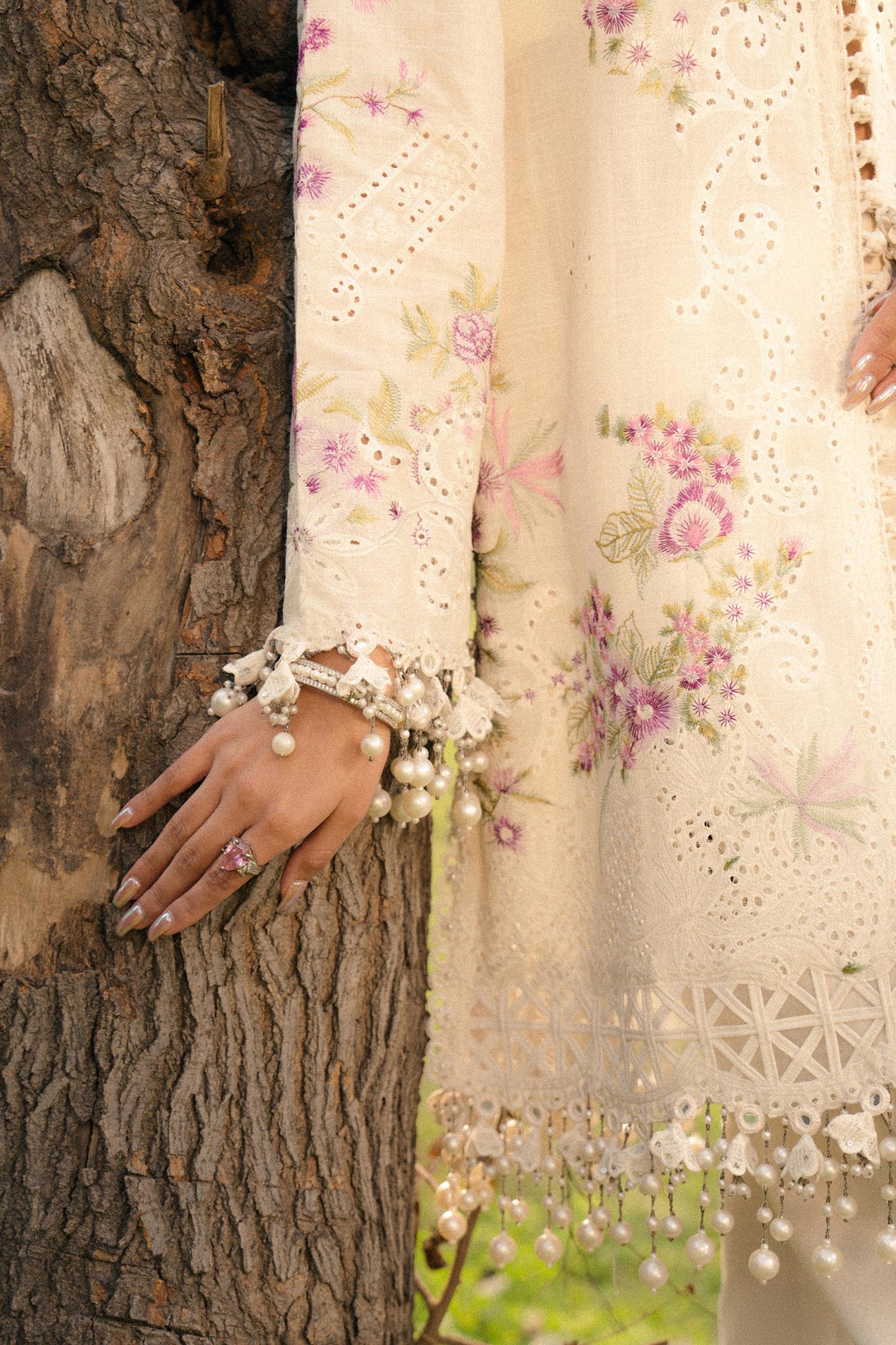 Model wearing ivory and pink embroidered outfit from Sana Safinaz, Luxury Lawn '25, perfect for Pakistani clothes online in UK.