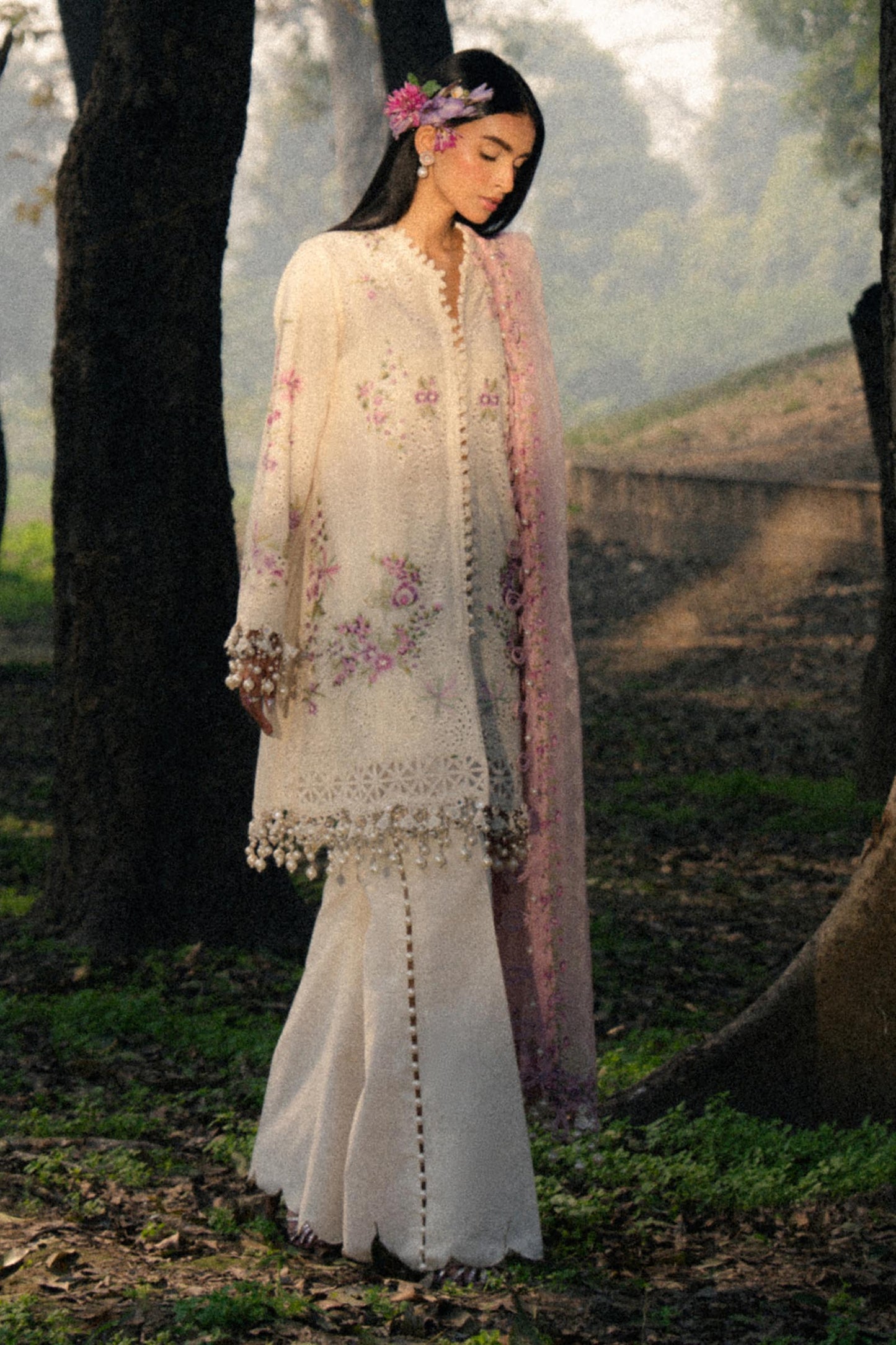Model wearing ivory and pink embroidered outfit from Sana Safinaz, Luxury Lawn '25, perfect for Pakistani clothes online in UK.