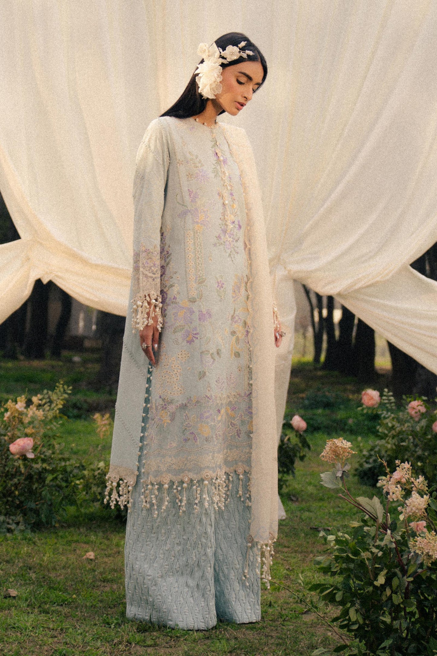 Model wearing pastel blue and ivory embroidered outfit from Sana Safinaz, Luxury Lawn '25, ideal for Pakistani clothes online in UK.