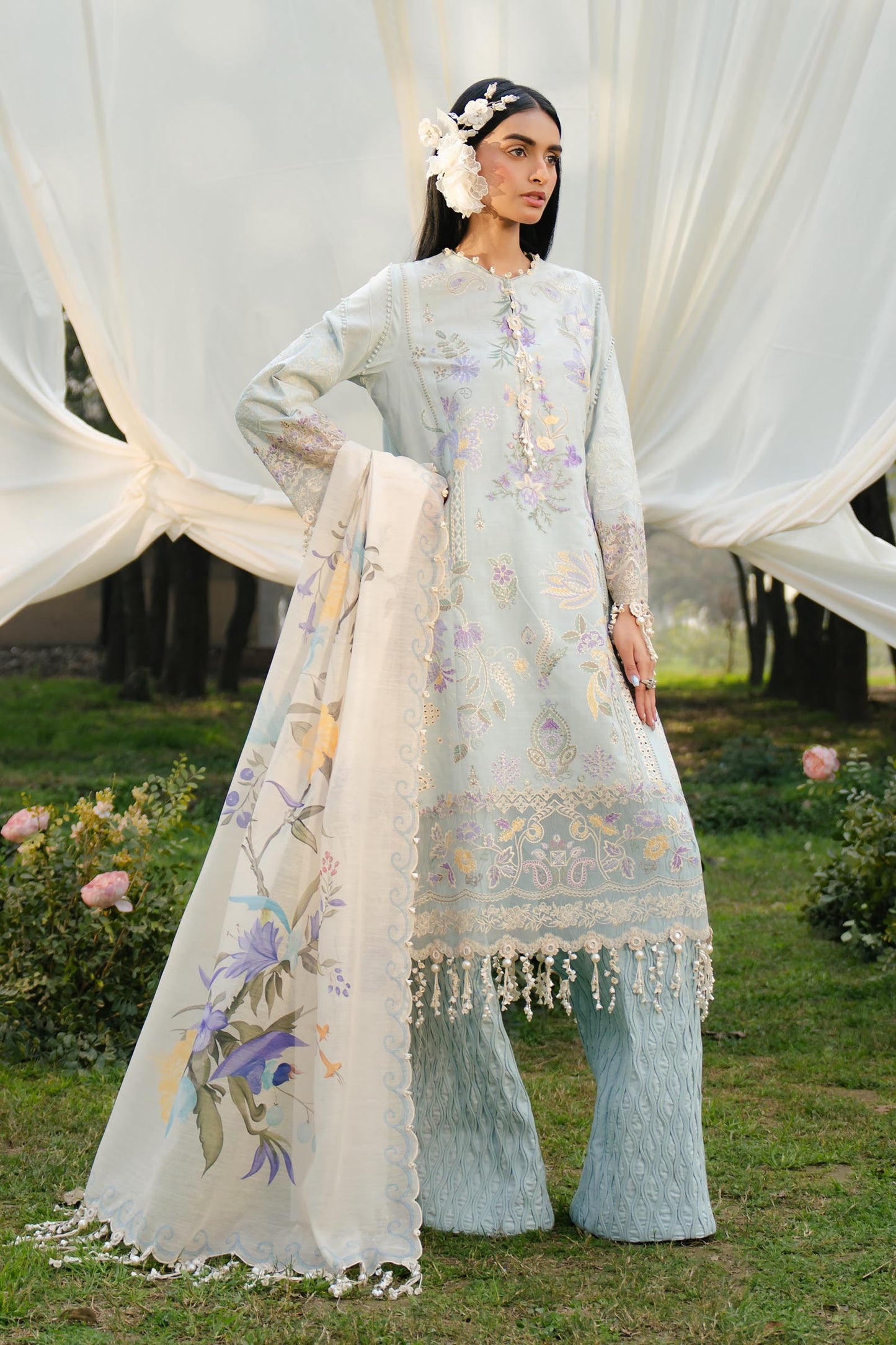 Model wearing pastel blue and ivory embroidered outfit from Sana Safinaz, Luxury Lawn '25, ideal for Pakistani clothes online in UK.