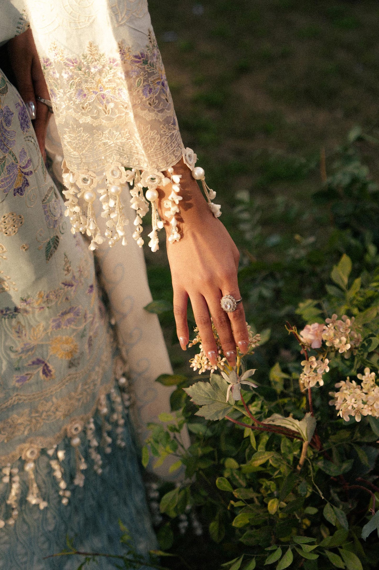 Model wearing pastel blue and ivory embroidered outfit from Sana Safinaz, Luxury Lawn '25, ideal for Pakistani clothes online in UK.