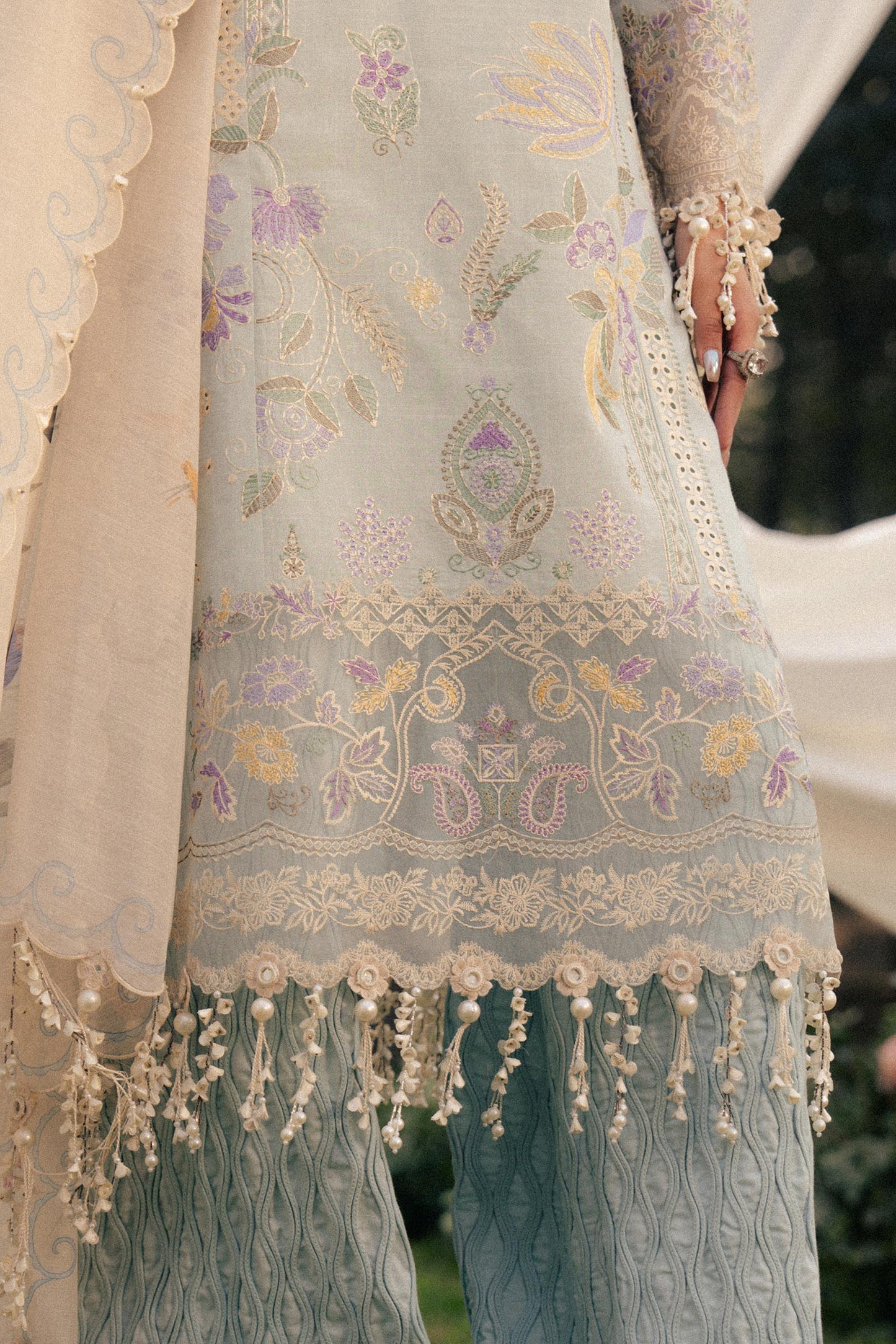 Model wearing pastel blue and ivory embroidered outfit from Sana Safinaz, Luxury Lawn '25, ideal for Pakistani clothes online in UK.