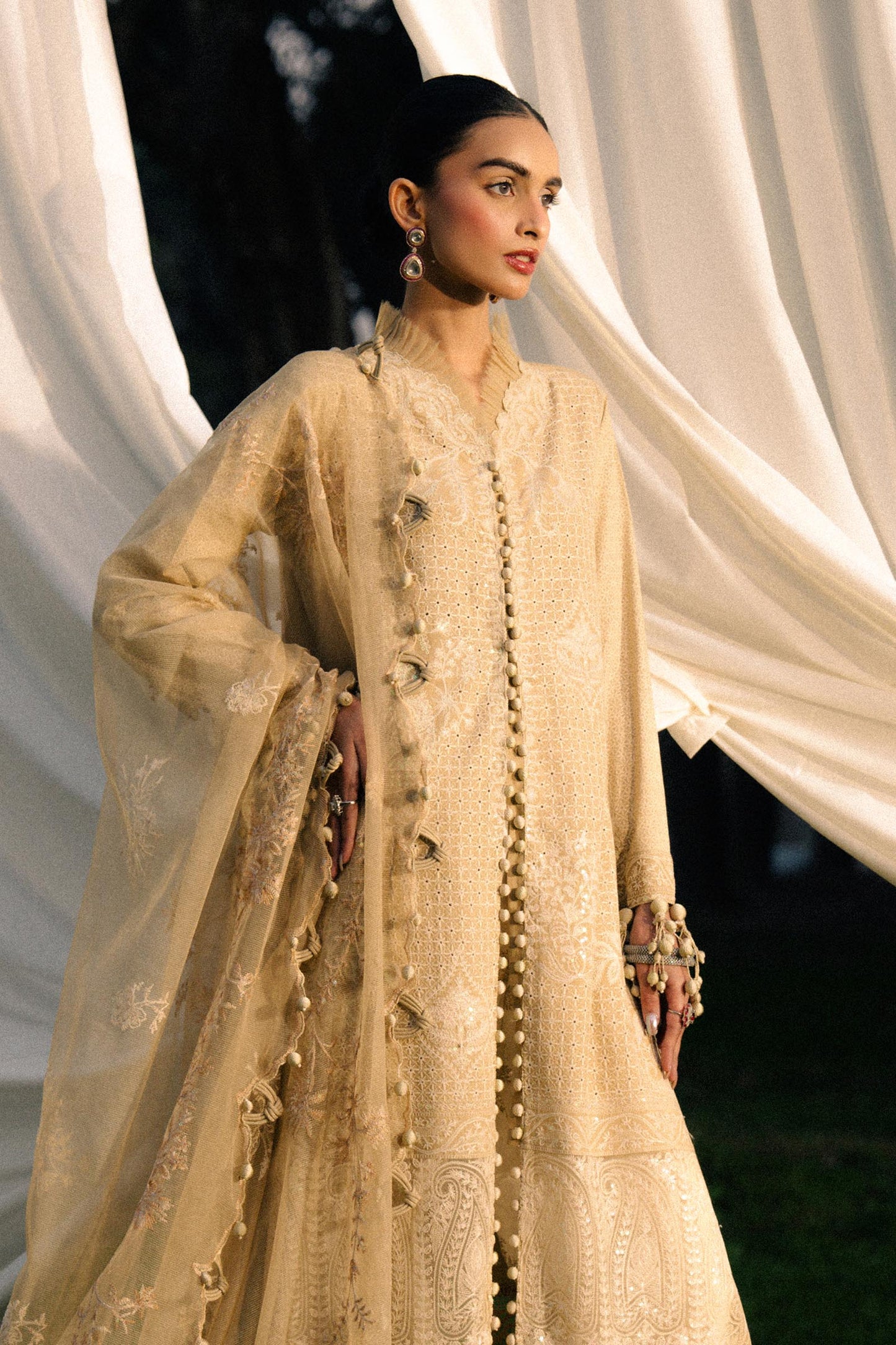 Model wearing beige embroidered outfit from Sana Safinaz, Luxury Lawn '25, perfect for Pakistani clothes online in UK and luxury pret.