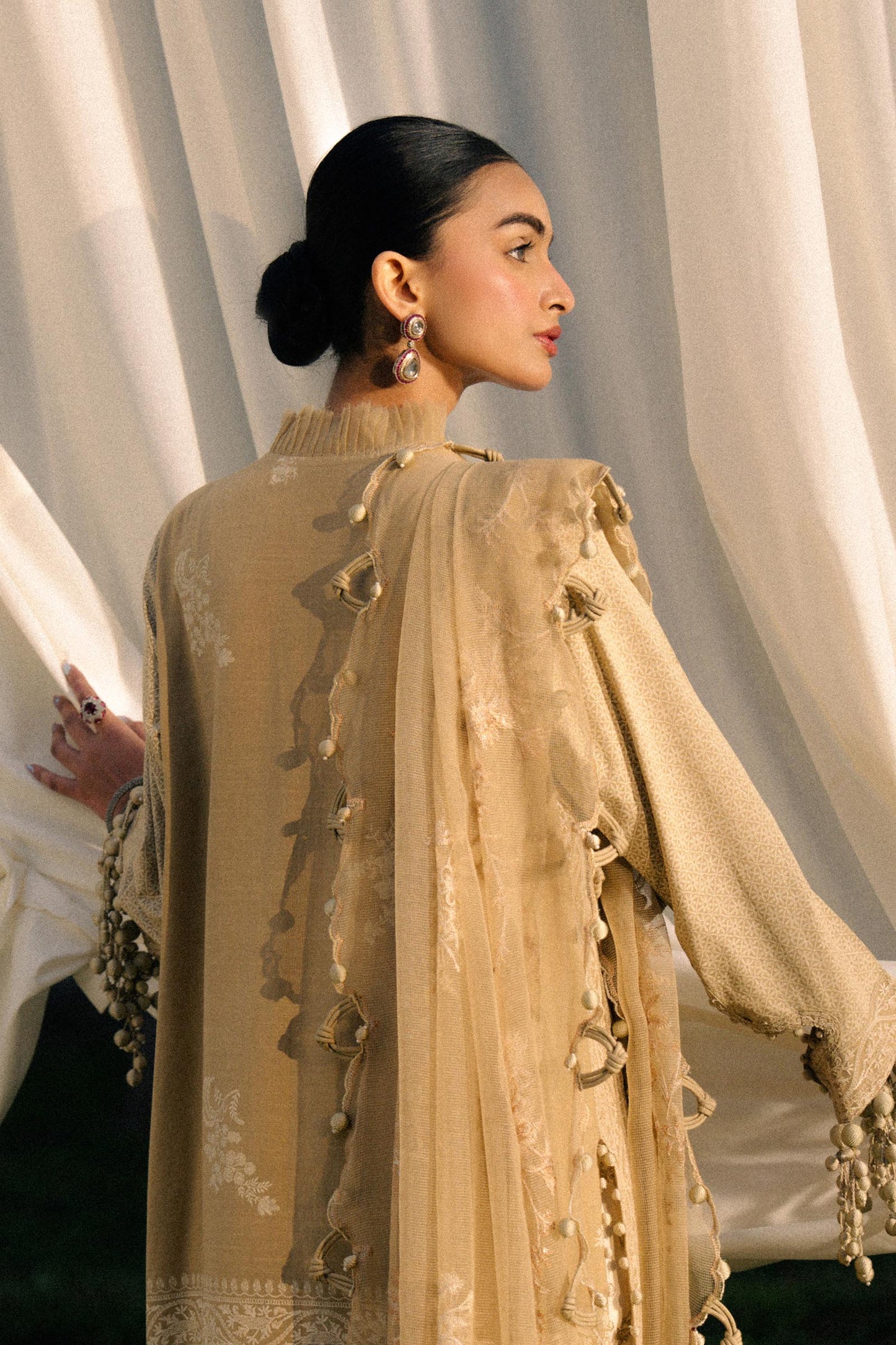 Model wearing beige embroidered outfit from Sana Safinaz, Luxury Lawn '25, perfect for Pakistani clothes online in UK and luxury pret.