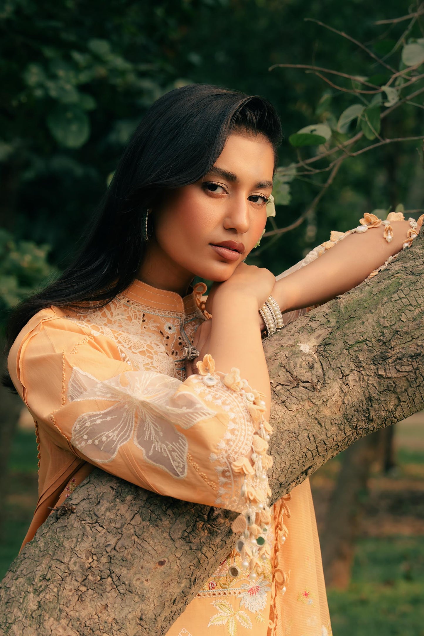 Model wearing mustard yellow embroidered dress with lace detailing from Sana Safinaz Luxury Lawn '25, Pakistani clothes online in UK.
