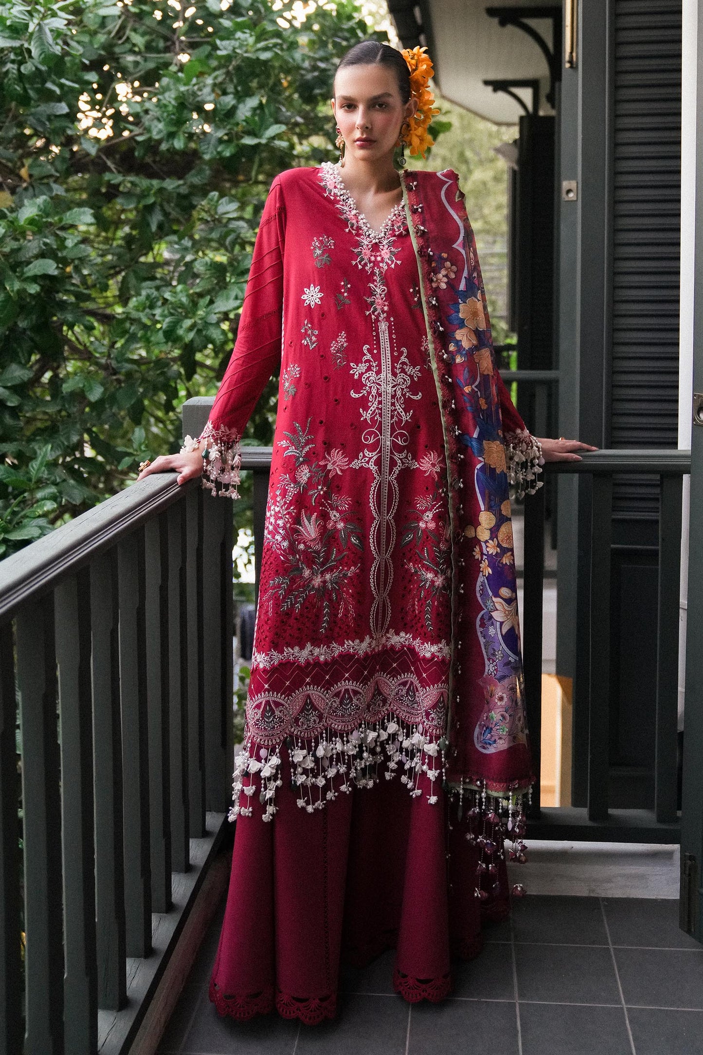 Model wearing deep red embroidered dress with multicolor dupatta from Sana Safinaz Luxury Lawn '25, Pakistani clothes online in UK.