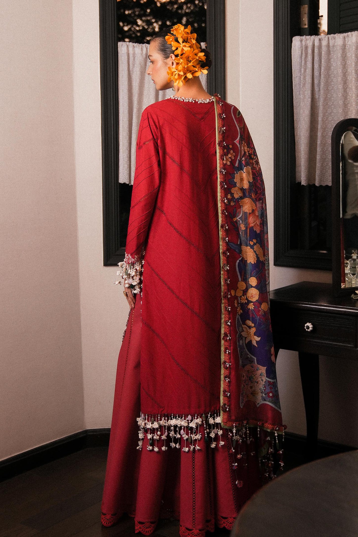 Model wearing deep red embroidered dress with multicolor dupatta from Sana Safinaz Luxury Lawn '25, Pakistani clothes online in UK.