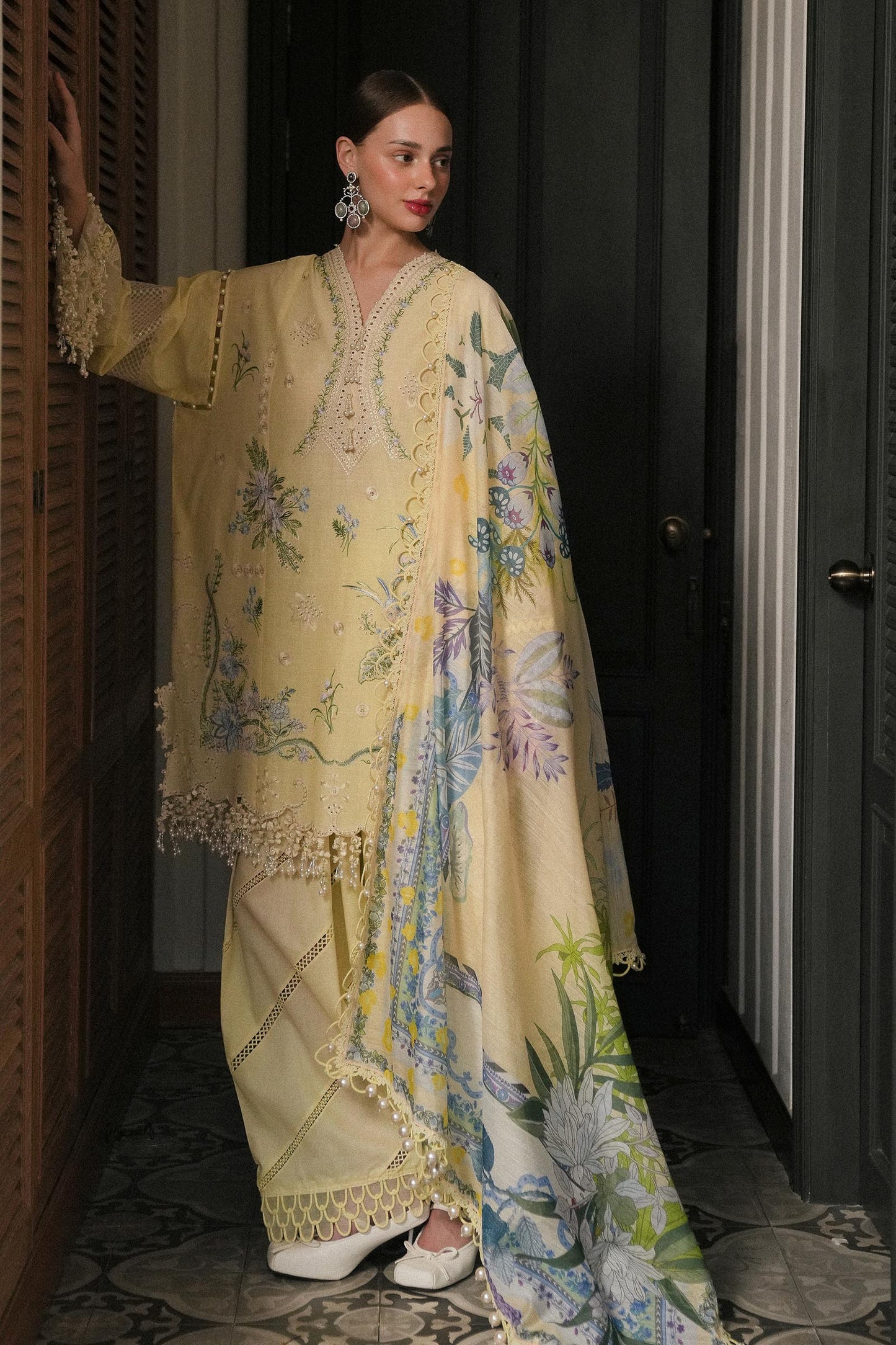 Model wearing lemon yellow embroidered dress with printed dupatta from Sana Safinaz Luxury Lawn '25, Pakistani clothes online in UK.