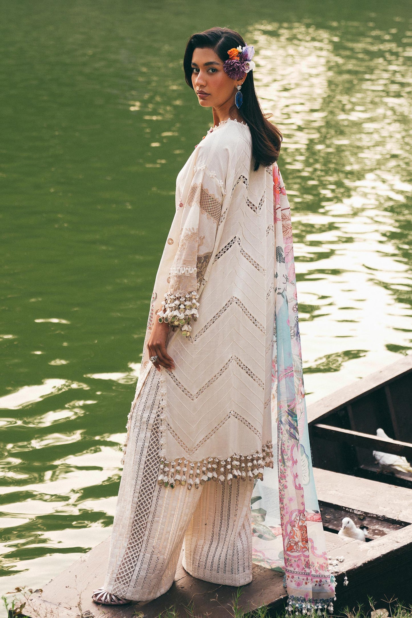 Model wearing ivory and pastel floral embroidered dress with printed dupatta from Sana Safinaz Luxury Lawn '25, Pakistani clothes online in UK.