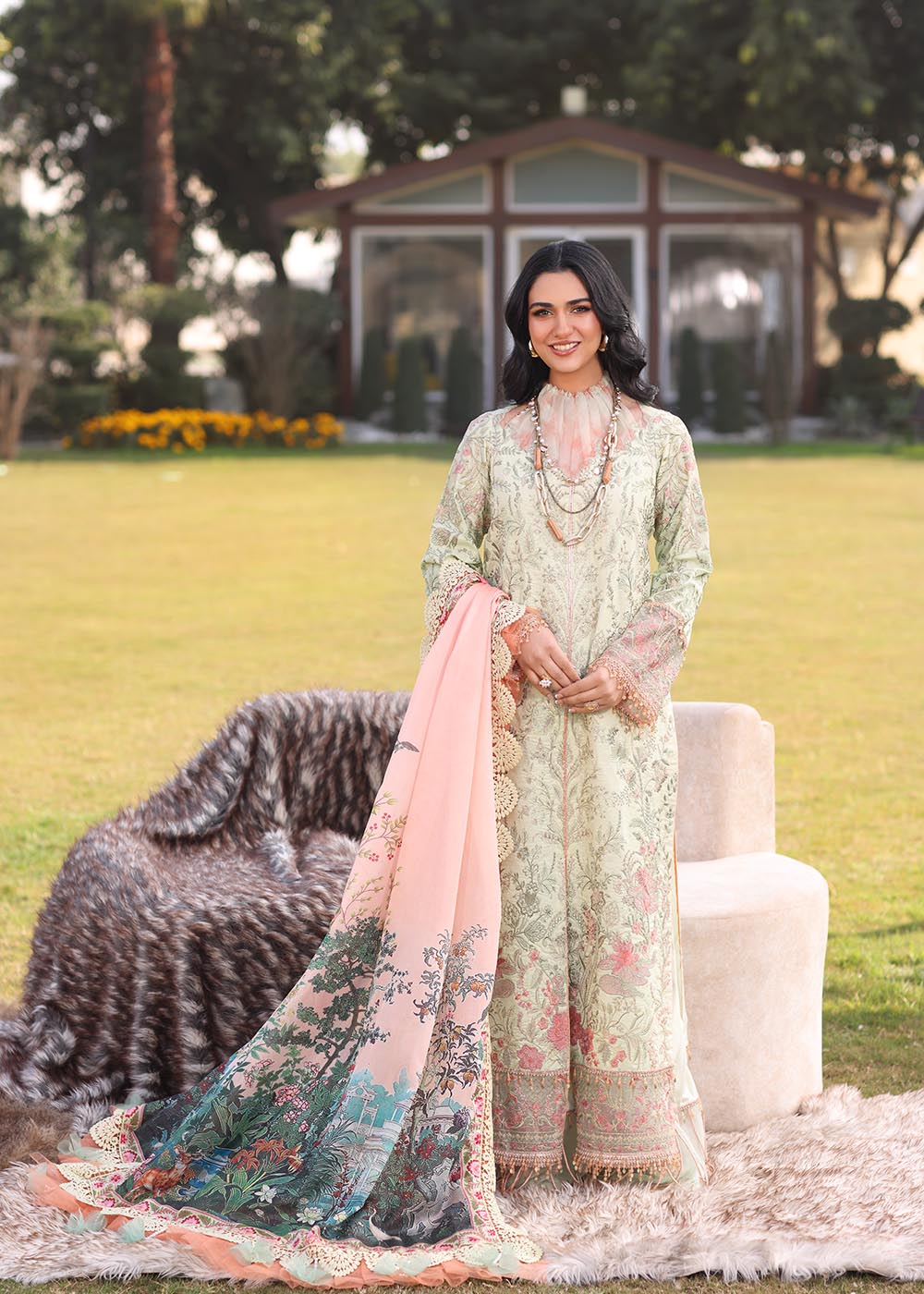 Model wearing light green and peach printed dress with floral dupatta from Musferah Saad Pretty Girls Luxury Lawn '25 Lilia, Pakistani clothes online in UK.