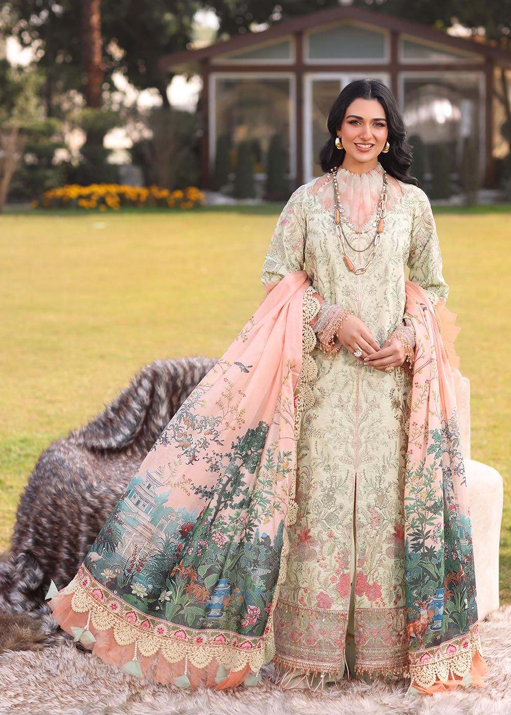 Model wearing light green and peach printed dress with floral dupatta from Musferah Saad Pretty Girls Luxury Lawn '25 Lilia, Pakistani clothes online in UK.