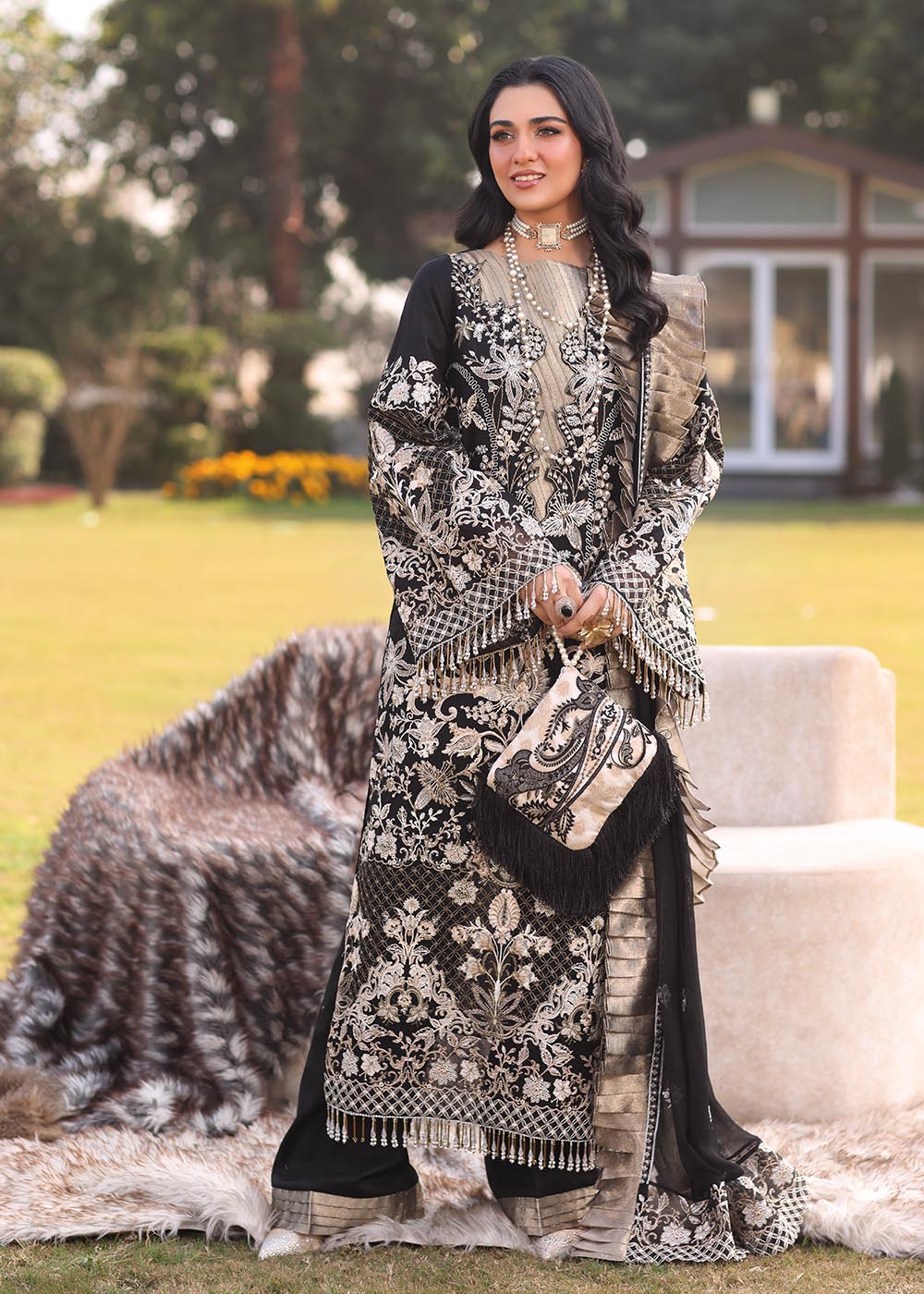 Model wearing black and gold embroidered dress with matching dupatta from Musferah Saad Pretty Girls Luxury Lawn 2025 Lustre. Pakistani clothes online UK.
