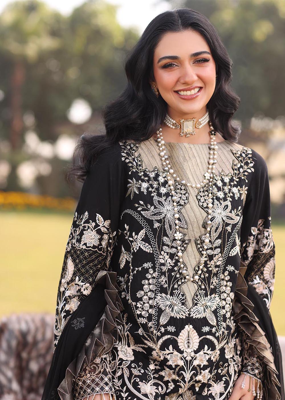 Model wearing black and gold embroidered dress with matching dupatta from Musferah Saad Pretty Girls Luxury Lawn 2025 Lustre. Pakistani clothes online UK.