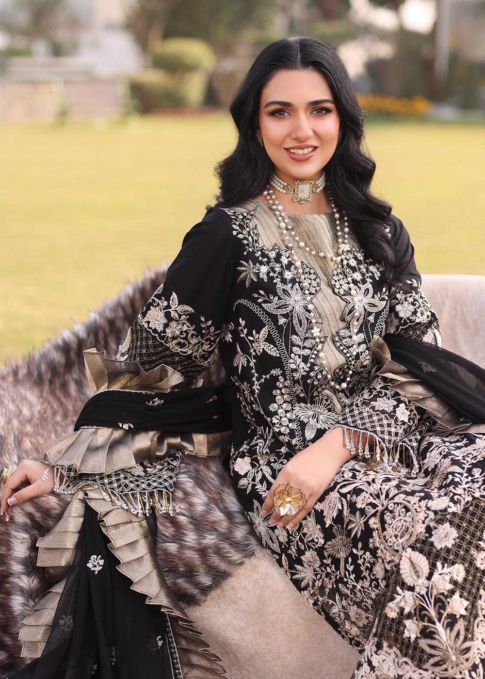 Model wearing black and gold embroidered dress with matching dupatta from Musferah Saad Pretty Girls Luxury Lawn 2025 Lustre. Pakistani clothes online UK.