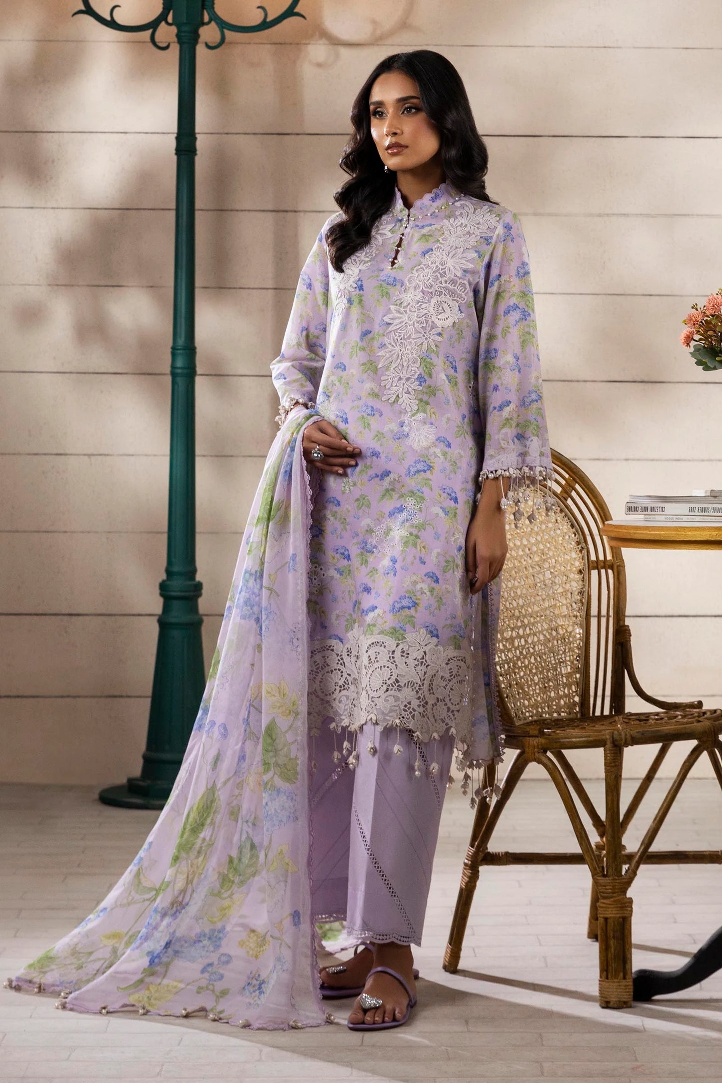 Model wearing lilac floral printed dress with white embroidery from Sana Safinaz Muzlin Spring '25, Pakistani Luxury pret online UK.
