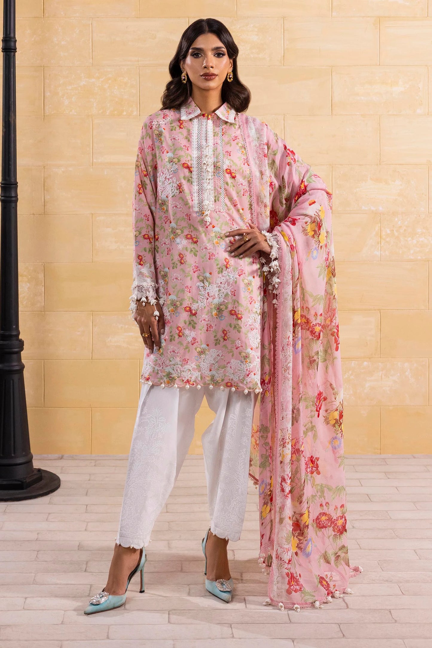 Model wearing pink floral print dress with white lace details and printed dupatta from Sana Safinaz Muzlin Spring '25, Pakistani clothes online UK.