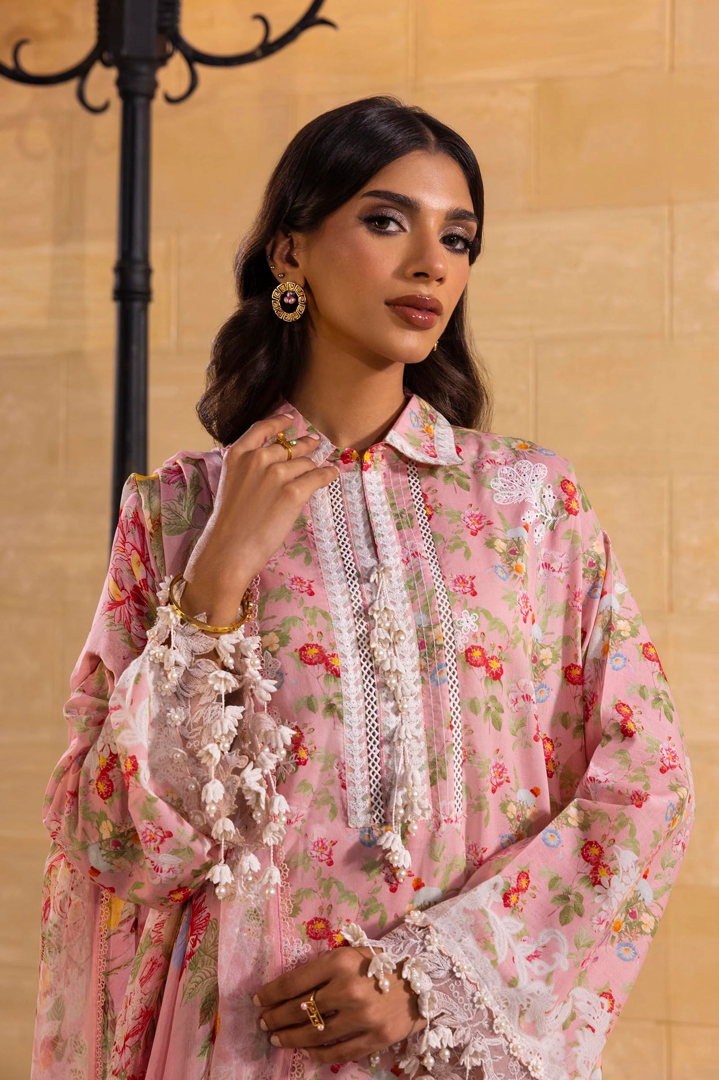 Model wearing pink floral print dress with white lace details and printed dupatta from Sana Safinaz Muzlin Spring '25, Pakistani clothes online UK.